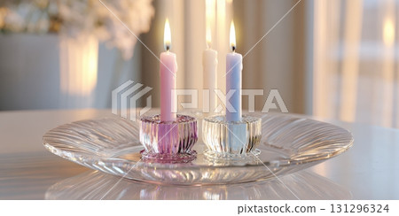 Crystal candle plate with pastel taper candles and soft wax drips in an elegant, tranquil home setting Crystal candle plate with pastel taper candles and soft wax drips in an elegant, tranquil home setting 131296324