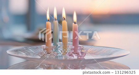 Crystal Glass Candle Plate with Dripping Wax and Burning Pastel Taper Candles in Elegant Interior Crystal Glass Candle Plate with Dripping Wax and Burning Pastel Taper Candles in Elegant Interior 131296325