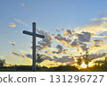 A great Christian cross in the landscape. A Christian cross highlighted by the sunset. The concept of religion and Christianity. 131296727