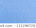 The coarse texture of a dark blue wall with a bold stain. The rough texture of a deep blue wall with an ink blot. The concept of background and textured surface. 131296728