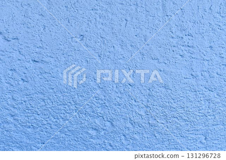 The coarse texture of a dark blue wall with a bold stain. The rough texture of a deep blue wall with an ink blot. The concept of background and textured surface. 131296728
