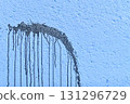 The coarse texture of a dark blue wall with a bold stain. The rough texture of a deep blue wall with an ink blot. The concept of background and textured surface. 131296729