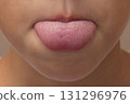 CloseUp of a Child Sticking Out Tongue 131296976