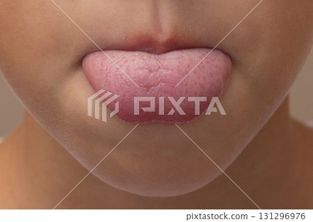 CloseUp of a Child Sticking Out Tongue CloseUp of a Child Sticking Out Tongue 131296976