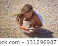 Child collecting stones 131296987