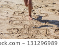 Childs Legs Jumping on Hopscotch in the Sand 131296989