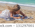 Young girl crafting a painted stone with vivid markers 131297001