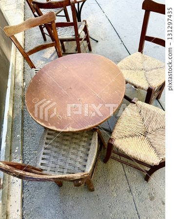 Outdoor seating area with table and chairs. A sunny summer day, a free table outside near the restaurant. 131297435