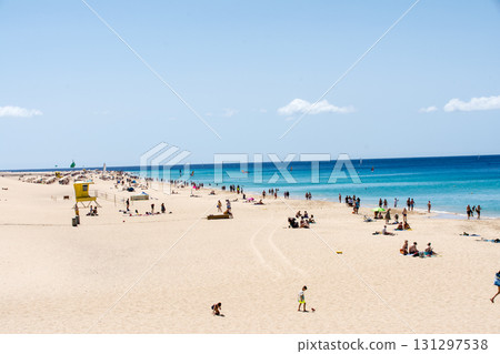 A beach with a wide sandy beach under a clear blue sky and a clear blue horizon, Fuerteventura, Canary Islands A beach with a wide sandy beach under a clear blue sky and a clear blue horizon, Fuerteventura, Canary Islands 131297538