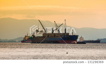 Cargo ship at sea during sunset. 131298369