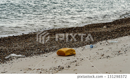 Single yellow sponge on sandy beach. Single yellow sponge on sandy beach. 131298372