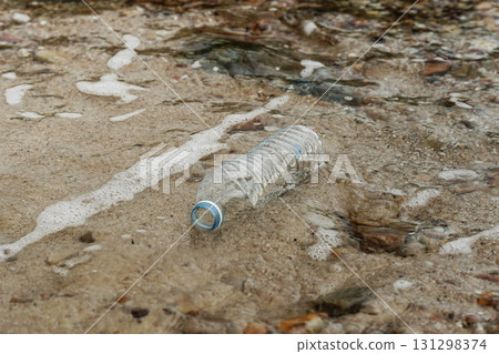 Plastic bottle on sandy beach pollution. 131298374