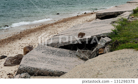 Destroyed road by coastal erosion 131298378