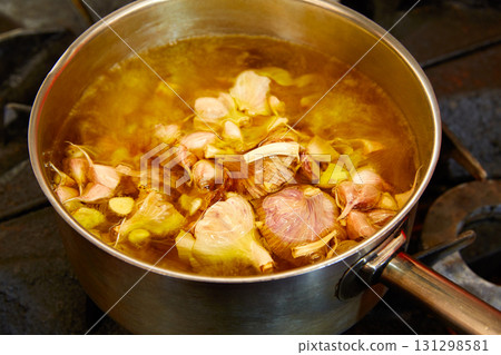 Garlic boiling soup in a pan 131298581