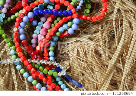 Color stones jewelry necklaces, straw background 131298694