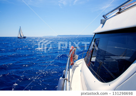 boat side view of blue ocean with sailboat 131298698