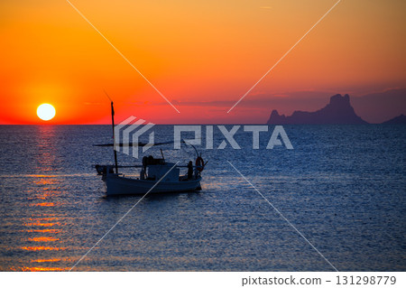 Ibiza sunset Es Vedra view and fisherboat formentera 131298779