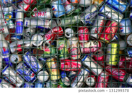 assorted beverages cans on the trash 131299378