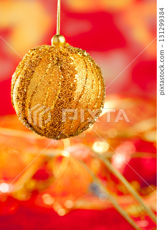 Christmas card of golden bauble and red blur 131299384