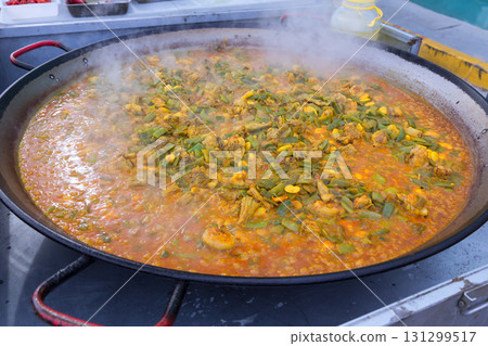 Cooking paella typical from Valencia Spain recipe with rice Cooking paella typical from Valencia Spain recipe with rice 131299517