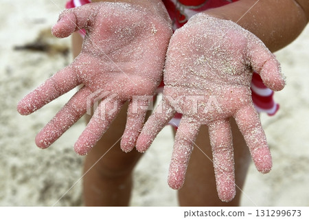 children girl beach sand hands facing camera 131299673