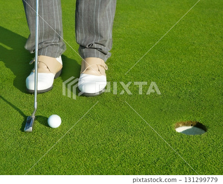 Golf green hole course man putting short ball Golf green hole course man putting short ball 131299779