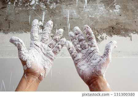 Astist plastering man hands with cracked plaster Astist plastering man hands with cracked plaster 131300380