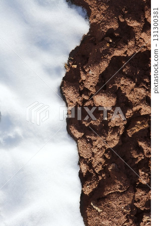 contrast snow and red clay mud soil vertical 131300381