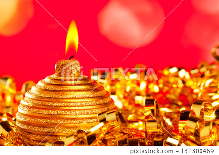 Christmas card of golden bauble candle on tinsel Christmas card of golden bauble candle on tinsel 131300469