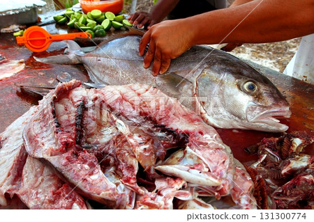 fishmonger preparing amberjack fish fillet 131300774