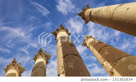 Roman Columns in the Jordanian city of Jerash (Gerasa of Antiquity), capital and largest city of Jerash Governorate, Jordan. Against the background of a beautiful sky with clouds 131301634