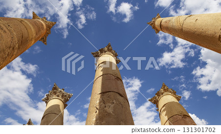 Roman Columns in the Jordanian city of Jerash (Gerasa of Antiquity), capital and largest city of Jerash Governorate, Jordan. Against the background of a beautiful sky with clouds 131301702