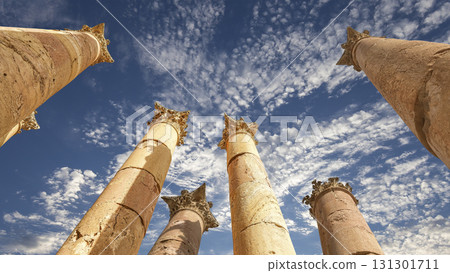 Roman Columns in the Jordanian city of Jerash (Gerasa of Antiquity), capital and largest city of Jerash Governorate, Jordan. Against the background of a beautiful sky with clouds Roman Columns in the Jordanian city of Jerash (Gerasa of Antiquity), capital and largest city of Jerash Governorate, Jordan. Against the background of a beautiful sky with clouds 131301711