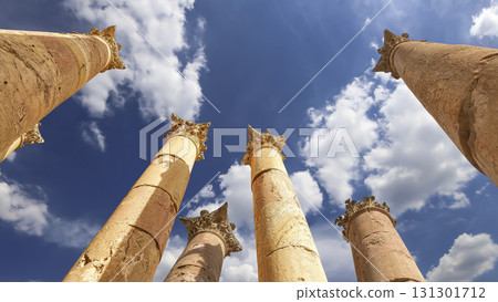 Roman Columns in the Jordanian city of Jerash (Gerasa of Antiquity), capital and largest city of Jerash Governorate, Jordan. Against the background of a beautiful sky with clouds Roman Columns in the Jordanian city of Jerash (Gerasa of Antiquity), capital and largest city of Jerash Governorate, Jordan. Against the background of a beautiful sky with clouds 131301712