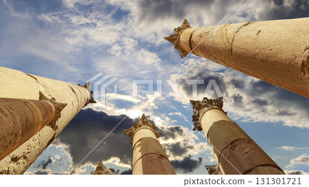 Roman Columns in the Jordanian city of Jerash (Gerasa of Antiquity), capital and largest city of Jerash Governorate, Jordan. Against the background of a beautiful sky with clouds Roman Columns in the Jordanian city of Jerash (Gerasa of Antiquity), capital and largest city of Jerash Governorate, Jordan. Against the background of a beautiful sky with clouds 131301721