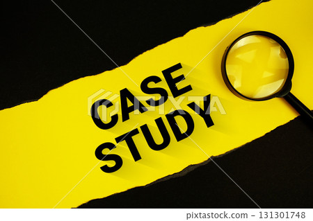 Case Study text on yellow with black paper torn ripped and magnifying glass 131301748