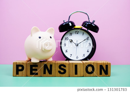 Pension alphabet letters with alarm clock on pink and green background Saving and financial concept 131301783