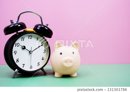 Piggy Saving with alarm clock on pink and green background 131301786