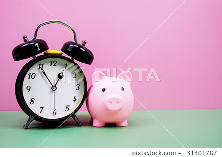 Piggy Saving with alarm clock on pink and green background 131301787