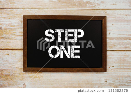 Step One text with gift box present and alarm clock on black background Step One text with gift box present and alarm clock on black background 131302276