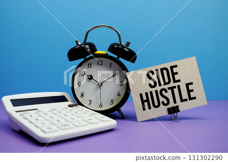 Side Hustle text with calculator and alarm clock on blue and purple background Side Hustle text with calculator and alarm clock on blue and purple background 131302290