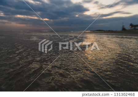 Low tide sea water retreating from sandy beach. Low tide sea water retreating from sandy beach. 131302468