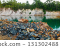 Abandoned quarry pond with rocky ground and turquoise water. 131302488