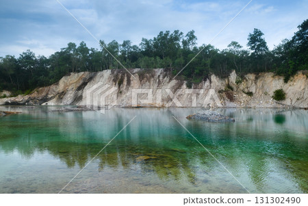 Abandoned quarry pond with turquoise water and trees. Abandoned quarry pond with turquoise water and trees. 131302490