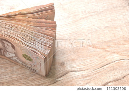 close up of Thai thousand banknote arranging on woodentable background and texture 131302508