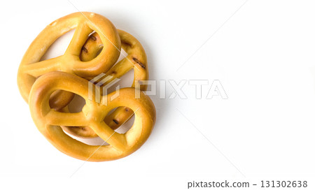 Soft pretzels sit on a clean white surface. 131302638