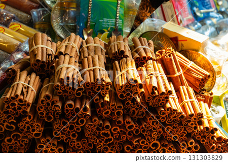 Aromatic cinnamon sticks displayed at a Turkish spice bazaar, symbolizing oriental flavors, traditional trade, and authentic culinary culture. 131303829
