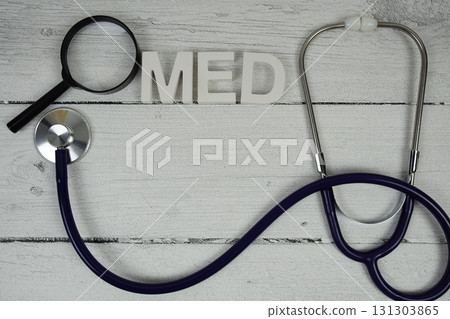MED Medicine text with Stethoscope on wooden background 131303865