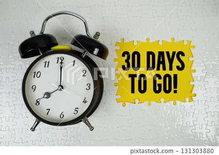 30 Days To Go! text with alarm clock on yellow background 131303880