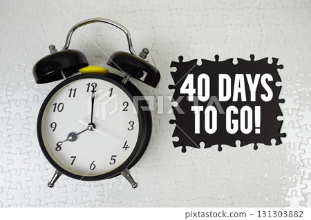 40 Days To Go! text with alarm clock on black background 40 Days To Go! text with alarm clock on black background 131303882